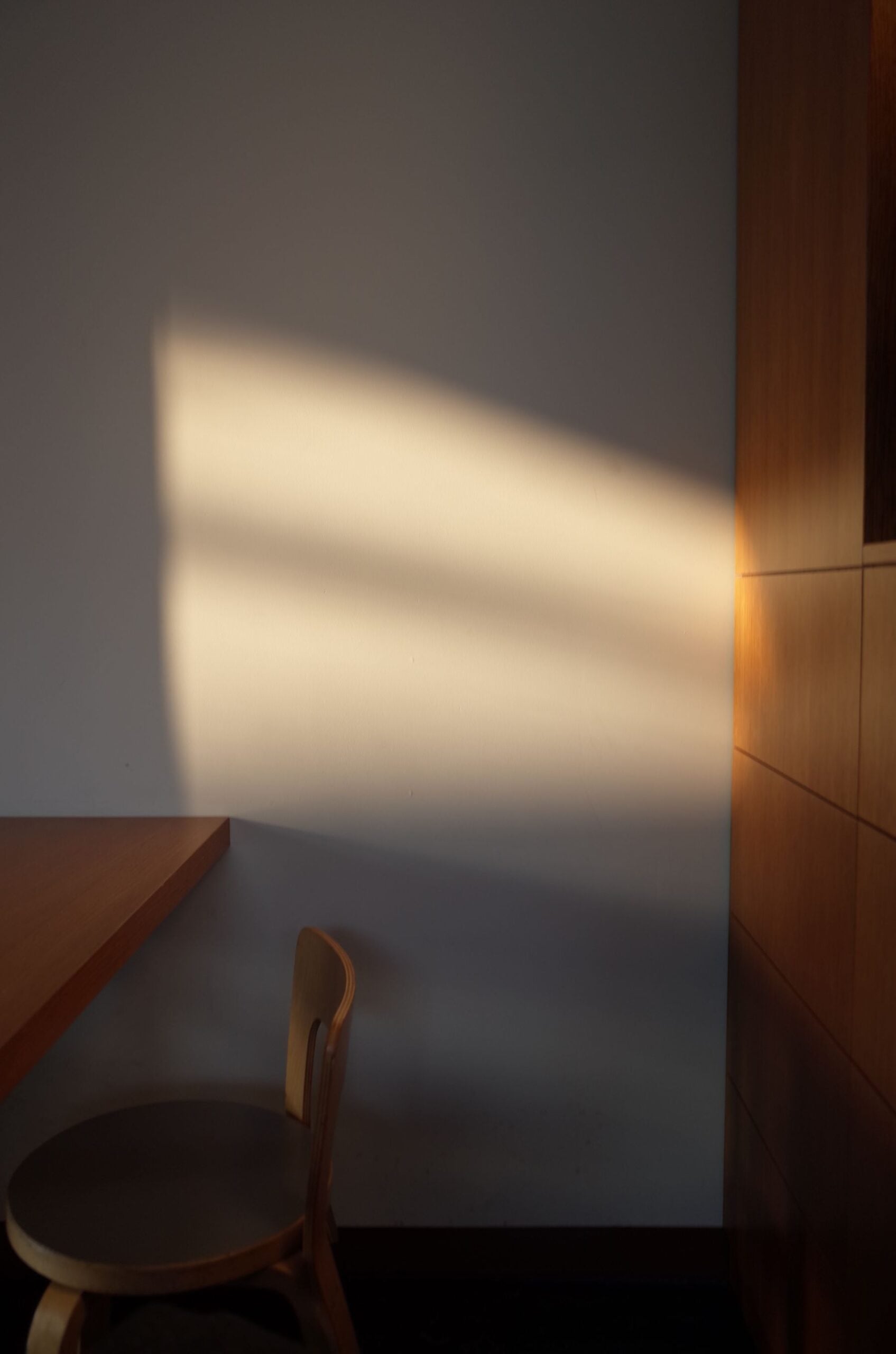 Warm afternoon light falling across a plain wall